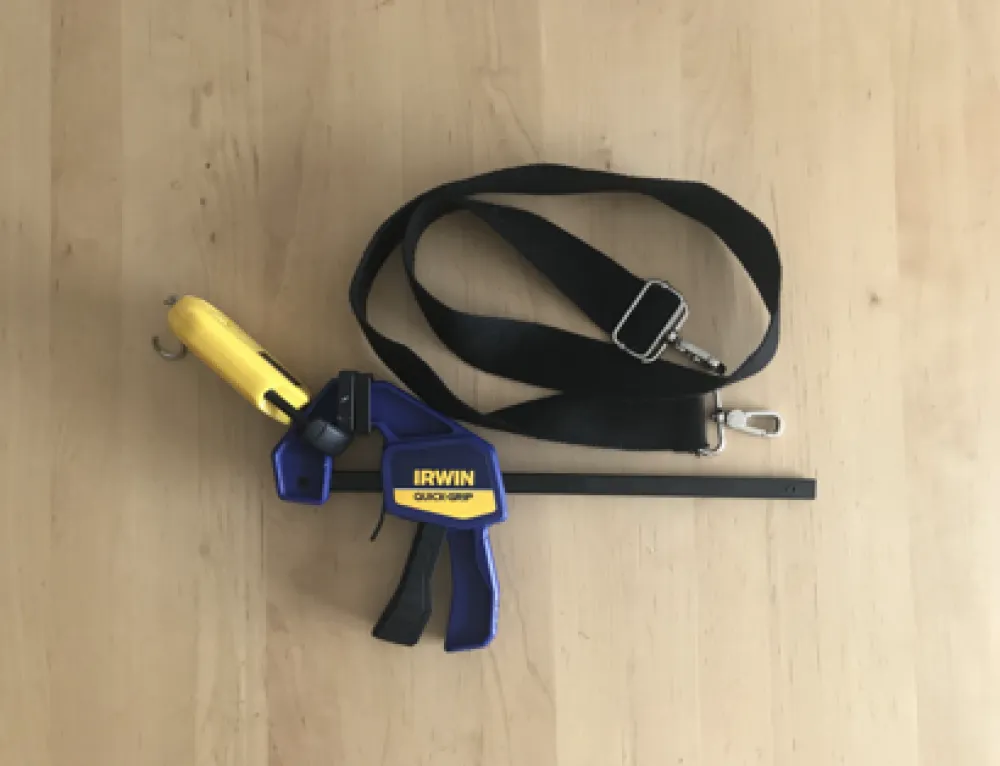 Trigger action clamp prototype parts, including: a trigger-action clamp, a luggage scale, and a hook and loop strap. 