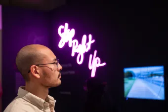 Photo of 2022 MFA Exhibition Over Under attendee interacting with Step Right Up installation